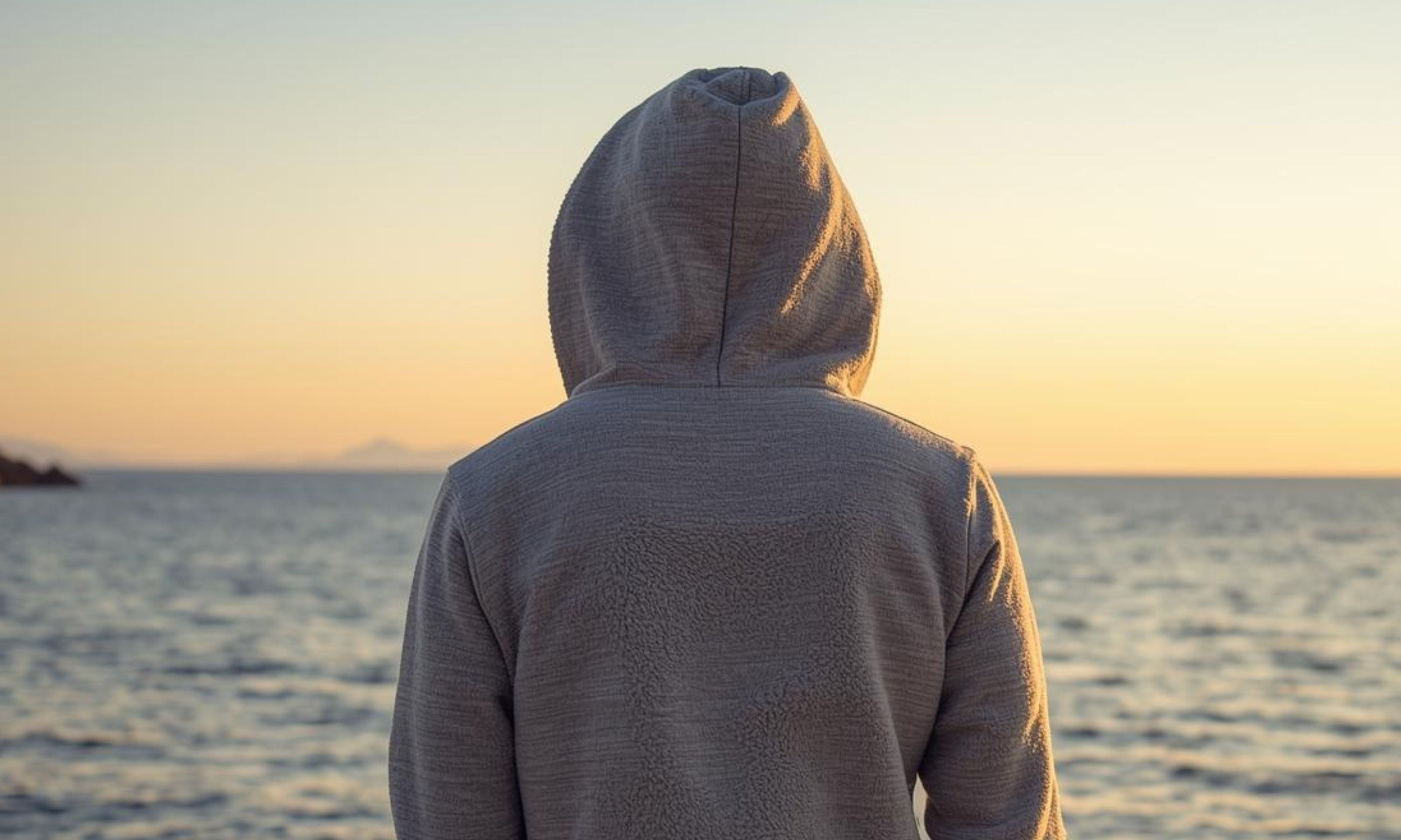 Cozy fleece fabric on a dock at sunset representing The Naughty Angler™ hoodies & sweatshirts.