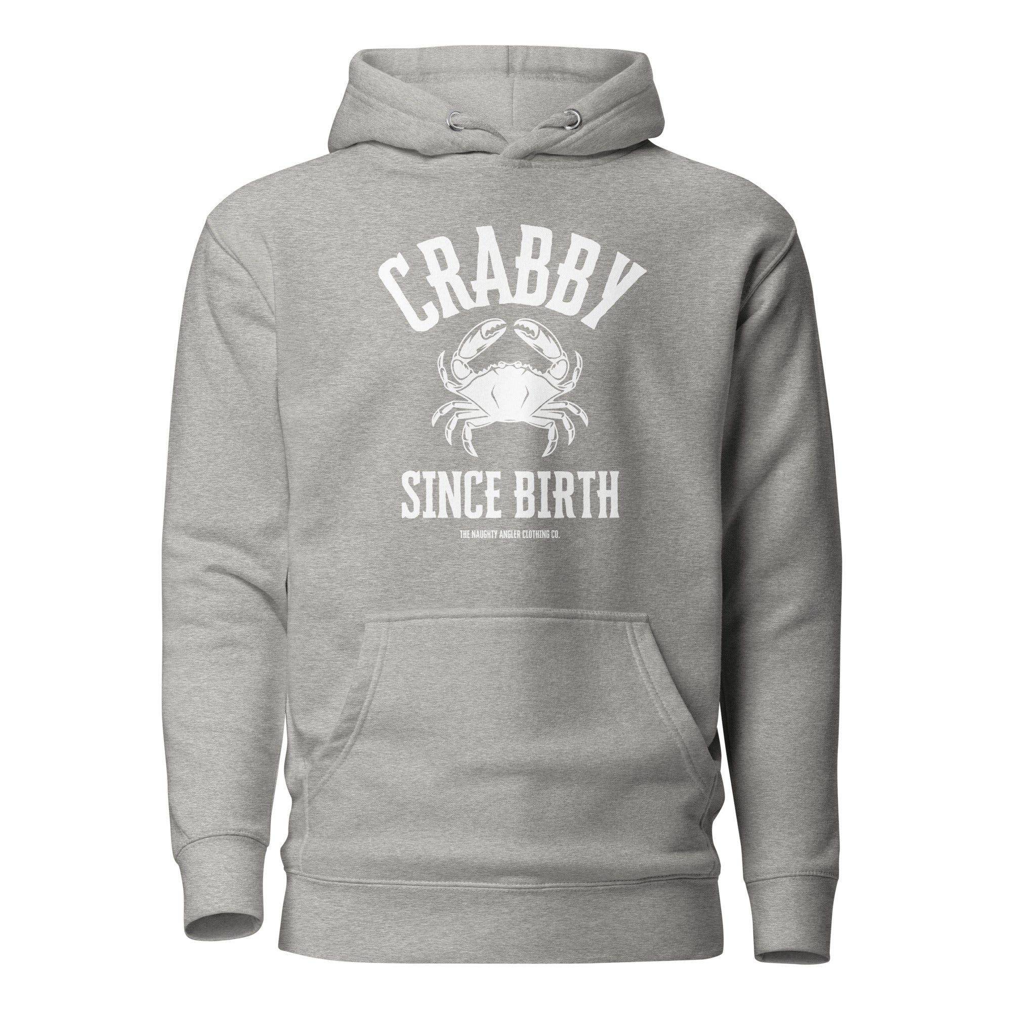 The Naughty Angler™ carbon grey unisex hoodie showcasing the “Crabby Since Birth” front design with a solid white centered crab graphic and bold white lettering, perfect for coastal and outdoor adventure fans.