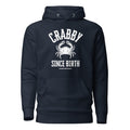 The Naughty Angler™ navy blazer unisex hoodie featuring the “Crabby Since Birth” design with a fully white centered crab graphic and bold white lettering, creating a clean high-contrast nautical look.