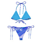 Back view of women’s ocean print recycled string bikini bottoms with fluid art design and white circular The Naughty Angler™ logo